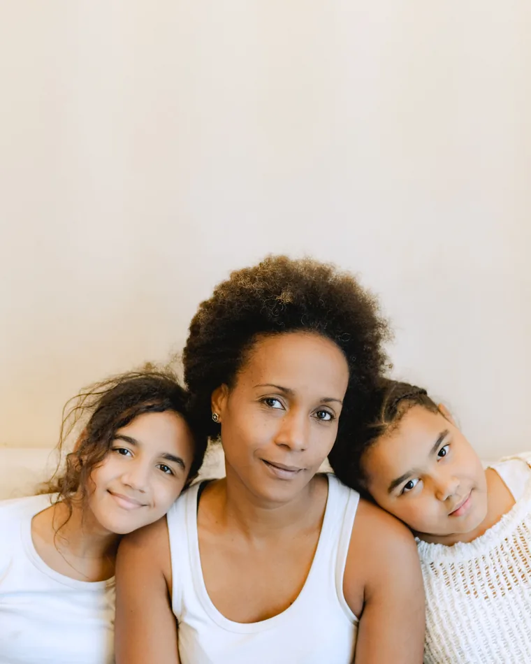 A mother with her two daughters at home